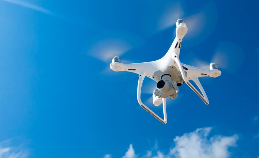 Lawmakers discussing mysterious drone sightings over New Jersey and New York with a drone image on a background screen.