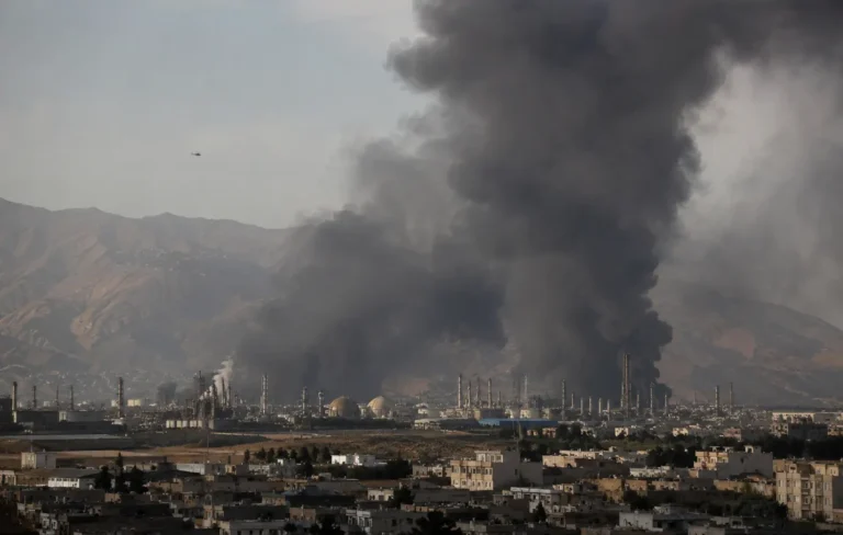 Massive black smoke rising from an industrial facility following a US-Israel air strike during the Iran Israel attack.